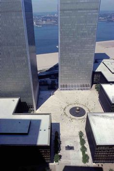 two tall buildings next to each other near the water