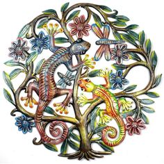 a metal tree with lizards and flowers on it