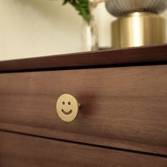 a close up of a drawer with a smiley face knob on it's side