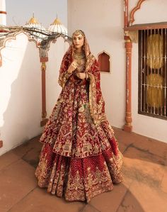 a woman in a red and gold bridal gown