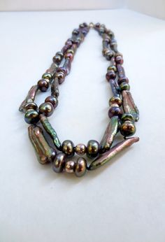 "What a beautiful, Vintage, color enhanced, Fresh Water Pearls and sterling silver beaded, double strand necklace. The fascinating clasp is stamped 925. The iridescent necklace measures: 20.5\". It's in great condition. Please see photos. This luscious piece of rare jewelry ships FREE within one to two business days. Please feel free to contact me prior to purchase to ask any questions you may have. Follow us on FB at Jackpot Jen Vintage. Thank you for your interest! Jackpot Jen Vintage 6932/21/ Handmade Double Strand Pearl Necklace, Elegant Iridescent Round Bead Necklaces, Elegant Iridescent Necklace With Round Beads, Elegant Iridescent Beaded Necklace, Silver Double Strand Pearl Beaded Necklaces, Silver Pearl Necklace With Colorful Beads, Elegant Iridescent Beaded Necklaces For Jewelry Making, Silver Double Strand Jewelry With Colorful Beads, Iridescent Polished Round Beads Jewelry