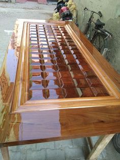 a wooden table that has been made with wood and glass inlays on it