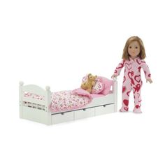 a doll is standing next to a bed with pink sheets and teddy bear on it