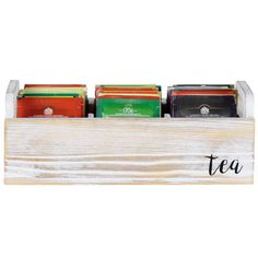 a wooden box filled with different types of teas on top of a white table