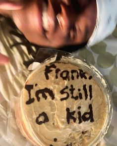 a cake with writing on it is being held by a woman