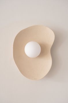 an egg is sitting in a bowl on the wall