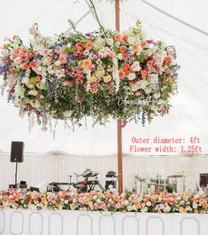 an outdoor event with flowers hanging from the ceiling