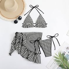 Make a splash in our sexy striped bikini set! This three-piece swimsuit includes a ruffle slide triangle swim top with halter ties that wrap around the neck and back for great support. The textured fabric and eye-catching striped print create a complex and dynamic look that's sure to turn heads. Plus, with removable soft padding cups, you can customize your comfort level to fit your needs.Pair the swim top with the matching Brazilian cheeky tie side string bikini bottom for a cohesive look that offers a super slim waistband design and simpler side profile. And don't forget the matching ruffle cover-up, which can be tied in a self-tie style for added versatility. Size (in) Bust Waist Hip S 31-33 24-26 35-37 M 33-35 26-28 37-39 L 35-37 28-30 39-41 Triangle Swim Top, Waistband Design, Corset Mini Dress, Tie Styles, Side Profile, Bustiers, Long Sleeve Mini, Textured Fabric, Swim Top