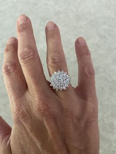 a woman's hand with a diamond ring on it