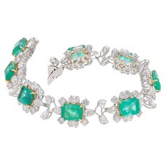 This is a stunning natural Zambian Emerald bracelet which has Emerald of very high quality and diamonds of very good quality . it has vsi clarity and G colour. Emerald : 19.35 cts diamonds : 12.67 cts gold : 19.406 gms Its very hard to capture the true color and luster of the stone, I have tried to add pictures which are taken professionally and by me from my I phone to reflect the true image of the item. It's a brand new piece so all measurements and Weight of the stone are accurate. Please rea Luxury Diamond Gemstone Bracelet, Luxury Diamond Gemstone Bracelets, Luxury Diamond Bracelets With Gemstones, Luxury Green Brilliant Cut Diamond Bracelet, Formal Emerald Diamond Bracelet With Brilliant Cut, Formal Emerald Gemstone Bracelets, Green Diamond Bracelet For Formal Occasions, Formal Emerald Diamond Bracelet, Luxury Gemstone Bracelet For Anniversary