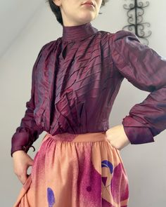 "Antique silk bodice c.1900. Made from a changeable shot silk, beautiful fabric, changes in the light from a dark pink to purple and blue. Full pouter style front bodice, high collar, full sleeves with mother of pearl cuff links. Boned and lined in cotton. Hooks and eye fastenings to inner bodice, outer blouse fuller also hook fastenings. Very good antique condition, hole in cotton lining, few scuffs to fabric. Strong and wearable. Chest 33\" Waist 26\" Across back seam to seam 12\" Collar 12\" Victorian Blouse With Buttons For Daywear, 1890s Shirt Waist, 1900s Blouse, Edwardian Lace Blouse, Edwardian Shirtwaist, Edwardian Blouse, Pearl Cuff, Gorgeous Blouses, Silky Blouse