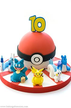 the pokemon birthday cake is surrounded by figurines