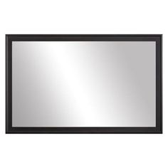 a black framed mirror on a white wall