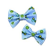 two blue and white bow ties with green tractors on the front, one has a yellow tractor