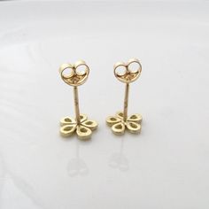 "14k yellow gold flower earrings with Blue Sapphire in the center of the flower. Gold stud earrings, made of five drops like shapes that together form a flower. These tiny earrings can be a beautiful gift for Mom and daughter, or for your wife. The earrings are gentle and would be a great combination with gold or pearl necklace. I am always inspired by how such basic shapes can enhance beauty. Available by custom order. Dimensions: Diameter: 8 m\"m Profile (width): 1 m\"m You can see these earri Yellow Gold Flower Cluster Earrings For Anniversary, 14k Gold Earrings With Flower Charm For Gift, 14k Yellow Gold Flower Earrings For Anniversary, Yellow Gold Flower Earrings In 14k, 14k Gold Flower Shaped Earrings For Anniversary, Yellow Gold Flower-shaped Earrings For Anniversary, Anniversary Yellow Gold Flower Shaped Earrings, 14k Gold Flower Earrings For Gift, 14k Gold Flower Earrings For Pierced Ears