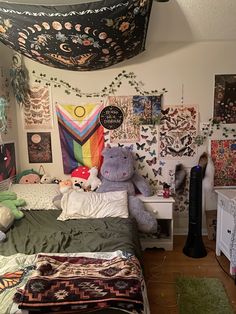 a bed room with a neatly made bed and lots of stuffed animals on the wall