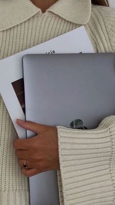 a woman holding a laptop computer in her hands