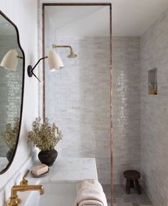 a bathroom with a sink, mirror and bathtub next to a bench in the corner