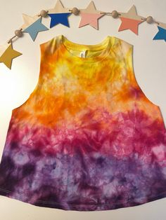 Super cute, bright ice dyed tank top, workout top, slightly cropped with a racer back. Perfect for exercising or wearing out with a bralette.  Each piece is hand dyed to order and one of a kind.   While the technique is similar for each item, please know that due to the process, your item will look similar to the picture but not exact.   Item should be washed in cold water for the first few washes to avoid bleeding to other clothes.  To preserve the color, continue to wash in cold water. All tan Sporty Tie Dye Tops For Summer, Summer Workout Crop Top, Summer Crop Top Tank For Yoga, Hand Dyed Rainbow Top For Summer, Acid Wash Sleeveless Tank Top For Festival, Multicolor Tank Top For Workout In Spring, Multicolor Tank Top For Summer Workout, Casual Multicolor Tank Top For Yoga, Cropped Tank Top For Gym In Summer