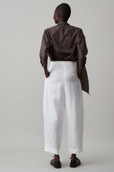 Our new Brady Pant is a riff on our favorite Elita pant. The Brady has a 1" waistband with belt loops and a gathered form. The back of these trousers are clean with small back darts. We have curved this outer leg which tapers at the hem. Cropped slightly to balance the extra volume. This pant is meant to sit at the natural/high waist and create an elongated leg. Pair with your favorite cropped top, soft blouse or lean into the volume and pair with big blazer. FINAL SALE Chic Tapered Leg Bottoms With Belted Cuffs, Cream Drapes, Black Drapes, Classic Trousers, Knit Outerwear, Jumpsuit Jacket, Summer Stripes, Natural High, Skirt Jumpsuit