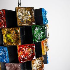 a multicolored glass sculpture hanging from a chain