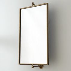 a mirror mounted to the side of a wall