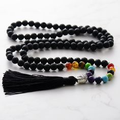 "Chakra 7 Black Lava Stone Mala 108 Necklace | Hand Knotted Mala Beads Necklace | Handmade Jewellery for Woman  You will receive: ⭐️ 1 x Handmade Chakra 7 Black Lava Stone Mala 108 Necklace  ⭐️ 100% Money Back Guarantee ⭐️ Free Shipping: US & Worldwide -  8mm Chakra 7 Black Lava Stone  -  Necklace length: 39-41inch -  Necklace weight: 120g - Tassel Length: 4.7inch Chakras are thought to provide subtle energy that helps your organs, mind, and intellect work at their best level. Chakras and spirit Spiritual Black Beaded Necklaces With Round Beads, Black Beaded Necklaces With Colorful Beads For Spiritual Use, Black Bohemian Beaded Bracelets For Meditation, Spiritual Black Beads For Jewelry Making, Spiritual Black Beaded Necklace With Colorful Beads, Black Beaded Mala As A Gift, Black Spiritual Beaded Necklace With Round Beads, Spiritual Black Beaded Necklaces With Colorful Beads, Black Beaded Mala As Gift