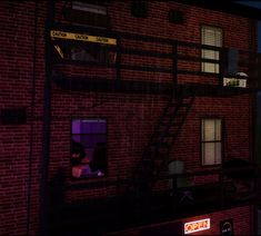 a person is sitting in the window of a brick building at night, looking out