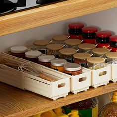 an organized spice rack in a kitchen with jars and containers on the shelf next to it