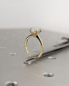 a diamond ring sitting on top of a metal surface