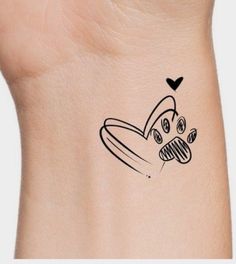 a small tattoo on the back of a woman's neck with a dog paw and heart