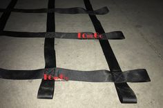 four black straps on the ground with red words that read toure, toure and toure