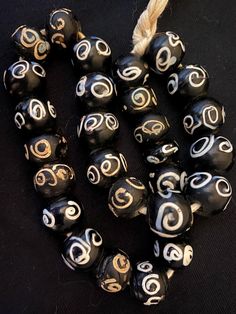 black and white beads with gold designs on them