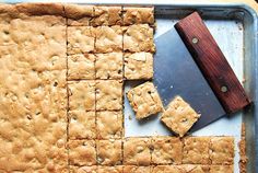 a cutting board with some cookies on it and a knife in the middle next to it