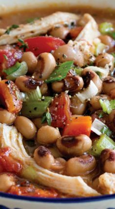 a bowl filled with beans and vegetables on top of a table