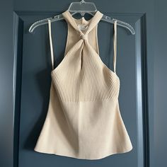 Tan/Cream Colored, Sleeveless Sweater Top. Keyhole Detail In Front. Elegant Beige Sleeveless Halter Top, Elegant Sleeveless Beige Halter Top, Beige Fitted Halter Neck Tank Top, Fitted Beige Halter Neck Tank Top, Beige Stretch Sleeveless Halter Top, Chic Fitted Neutral Tank Top, Chic Neutral Fitted Tank Top, Chic Beige Fitted Halter Top, Beige Stretch Halter Neck Tank Top