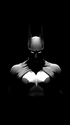 the dark knight batman is standing in the dark with his hands on his chest and eyes closed