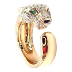 Cartier Panther 18k Yellow Gold Diamond Emerald Onyx Band Ring Paper  This ring comes with service paper from Cartier store in NYC. Retail Price: $24,300  Metal: 18k Yellow Gold Measurements:  Width: 11mm Weight: 13.2 grams Stones: Round brilliant cut diamonds VVS1 clarity, E color total weight approx. 1.15ct.  Ring Size: European 52 US 6 Hallmarks: Cartier 750 52 369XXX (serial number omitted)  Dimensions reference the ring size and are not specific to the ring itself. Cartier Jaguar Ring, Luxury Cartier Jewelry With Vs Clarity, Cartier 14k Gold Luxury Diamond Ring, Luxury Cartier 14k Gold Diamond Ring, Luxury 14k Gold Cartier Diamond Ring, Luxury Polished Emerald Ring, Luxury Yellow Gold Emerald Ring For Formal Occasions, Cartier 14k Gold Fine Jewelry Diamond Ring, Luxury Cartier Rings For Formal Occasions