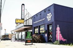 the outside of a restaurant with neon signs