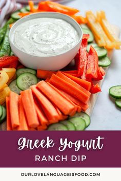 a bowl of ranch dip surrounded by vegetables and cucumbers