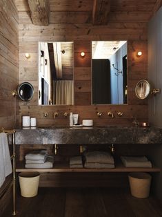 a bathroom with wooden walls and wood floors