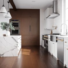 a kitchen with marble counter tops and white cabinets, along with wooden floors that match the hardwood flooring