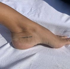 a person's foot with a small tattoo on the top and bottom of it