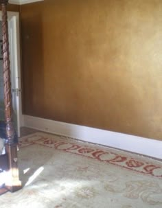 an empty room with brown walls and white carpet