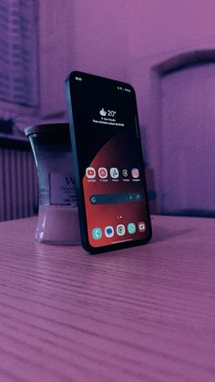 a cell phone sitting on top of a wooden table