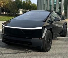 an electric car parked in front of a building