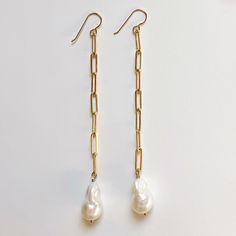 A classic pearl drop earring with 3 different lengths to choose from. 3 links for an elevated everyday staple, 5 links for a bit more drama, or 7 links for a mega statement. Pearl size increases with each length to keep the proportions in check. All suspended from 14k gold filled cable chain and french ear hooks. Everyday Long Drop Pearl Earrings With Charm, Everyday Long Drop Pearl Chain Earrings, Classic Everyday Pearl Chain Earrings, Classic Pearl Earrings With Pearl Chain For Everyday, Classic Dangle Earrings With Cable Chain, Classic Pearl Chain Earrings For Everyday Wear, Elegant Everyday Earrings With Paperclip Chain, Drop Earring, Ear Hook