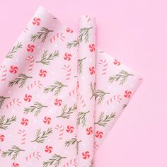 wrapping paper with candy canes on pink background