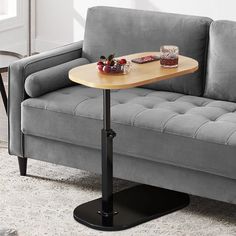 a couch and table with drinks on it in a small living room or dining area