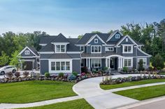 a large gray and white house with lots of windows